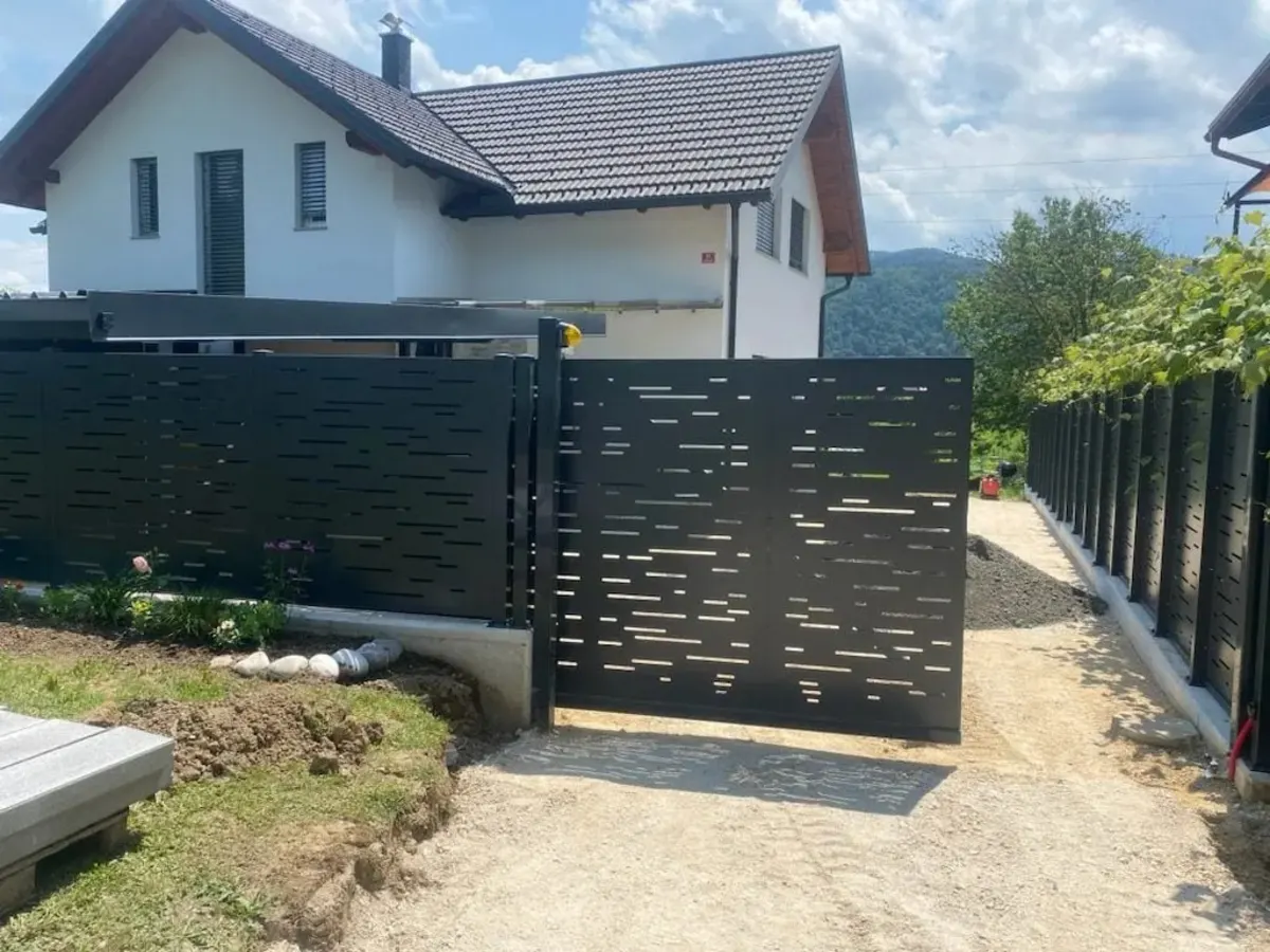 Perforirana ograja in vrata ob novi hiši